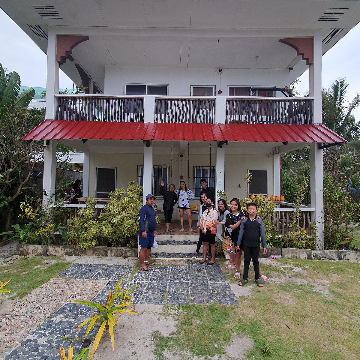 Happy's Homestay building exterior with guests posing outside the entrance garden